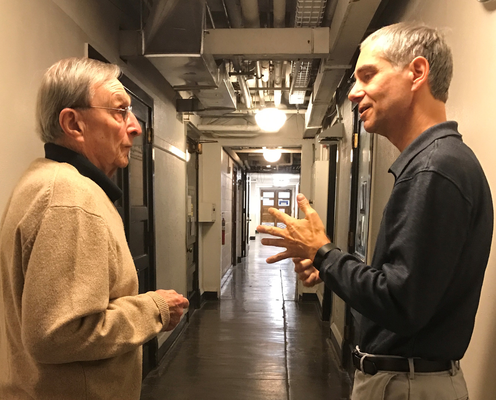 Richard Dehm and Martin Gruebele, talking in a hallway in Noyes Lab