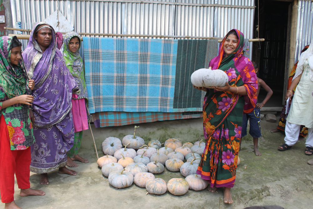 A farmer shows off her pumpkin harvest in Dinajpur district, Bangladesh.