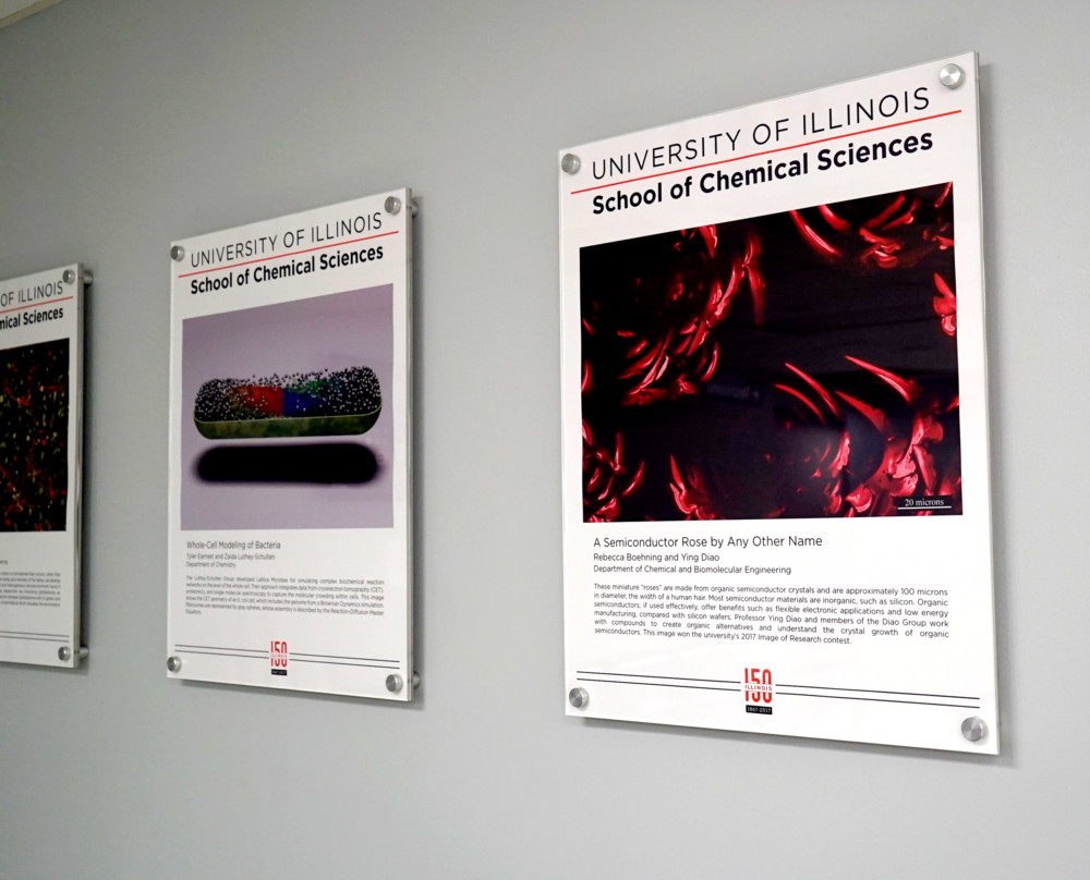 3 research artwork posters on a grey wall at Willard Airport