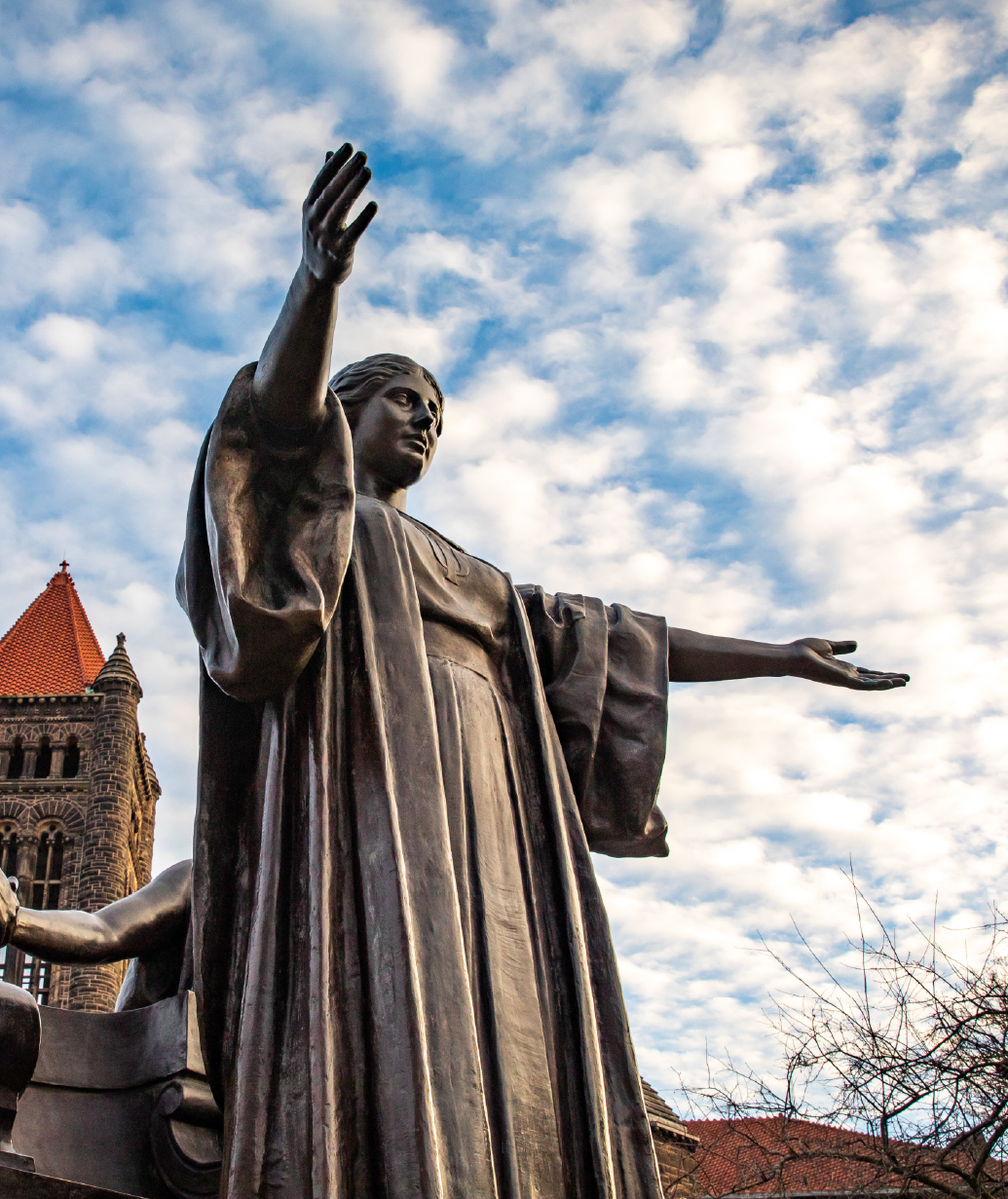 Alma statue standing proudly in front of a blue sky scattered with clouds