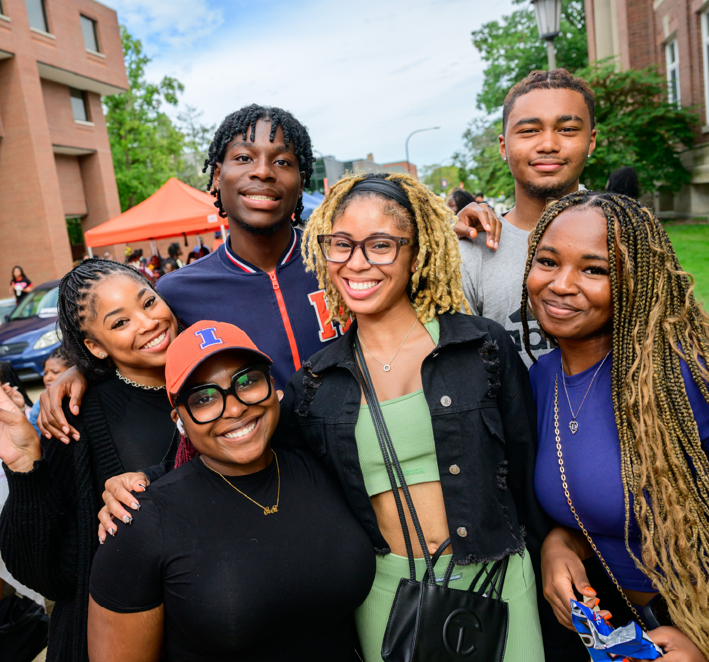 A group of students smiling at a campus event