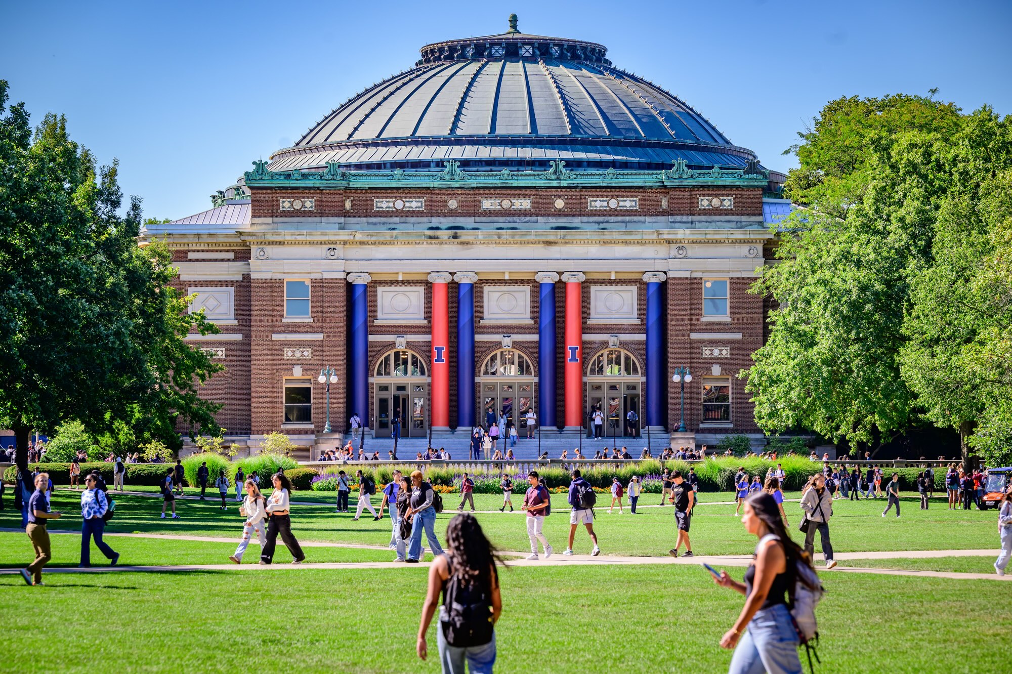 Main Quad with people walking in front of Foellinger Auditorium.