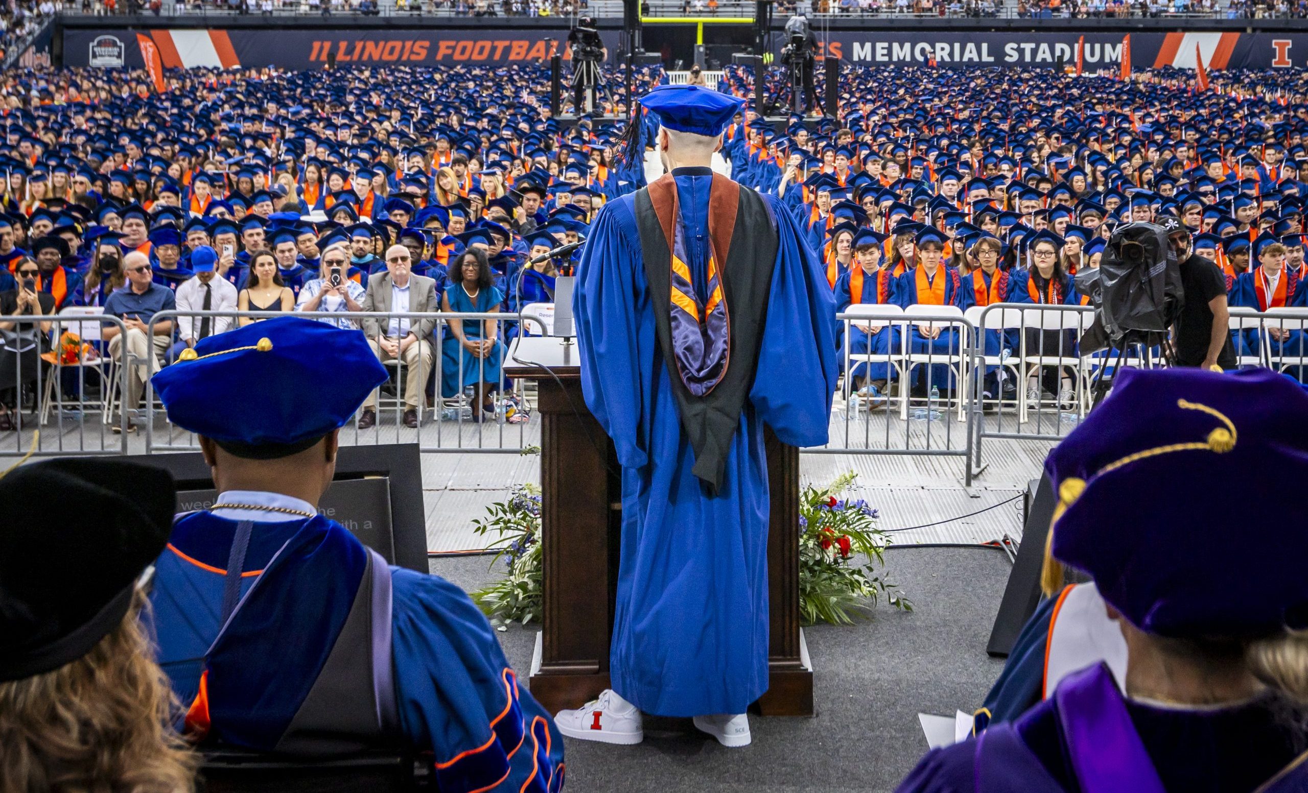 Sean Evans wearing academic regalia gives a Commencement speech.